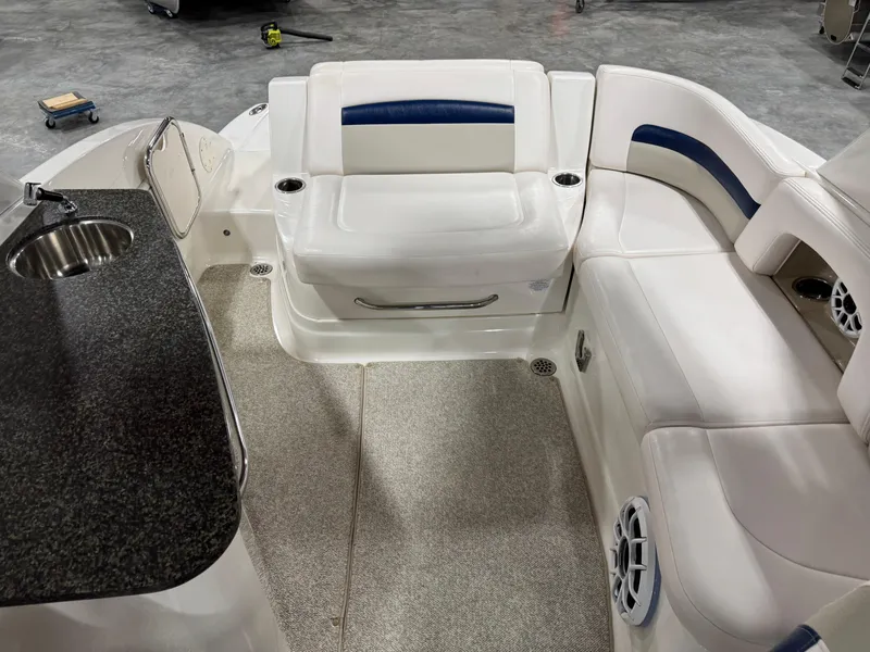 Slide: The Image of 2010 Chaparral 264 Sunesta boat interior with seating and countertop. - 12