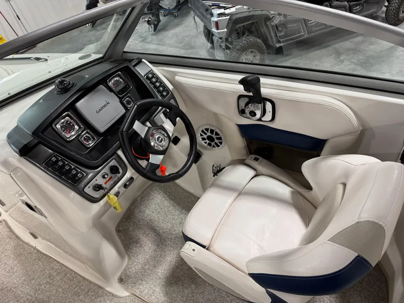 Slide: The Image of 2010 Chaparral 264 Sunesta boat cockpit with steering wheel and control panel. - 16