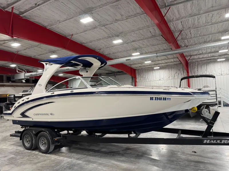 Slide: The Image of 2010 Chaparral 264 Sunesta boat on trailer in indoor storage facility. - 2