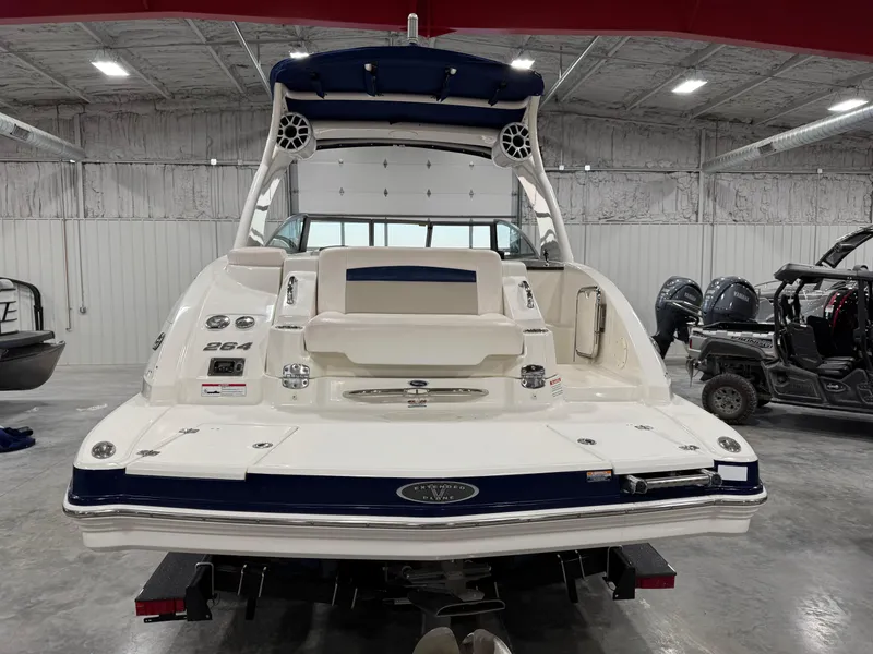 Slide: The Image of 2010 Chaparral 264 Sunesta boat in a showroom, rear view. - 5