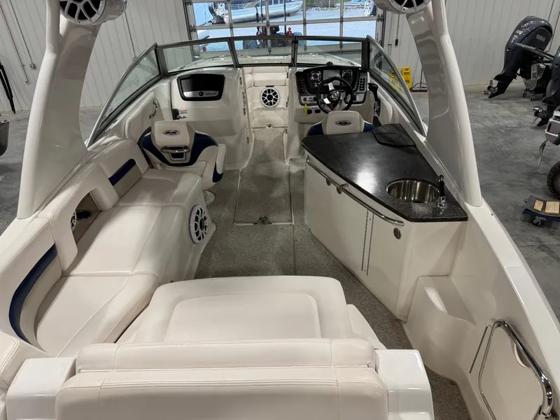 Slide: The Image of 2010 Chaparral 264 Sunesta boat interior with white seating and sleek dashboard. - 6