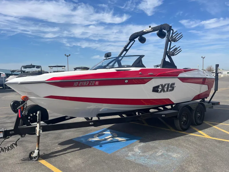 Slide: The Image of 2021 Axis A22 boat on trailer in parking lot under blue sky. - 10