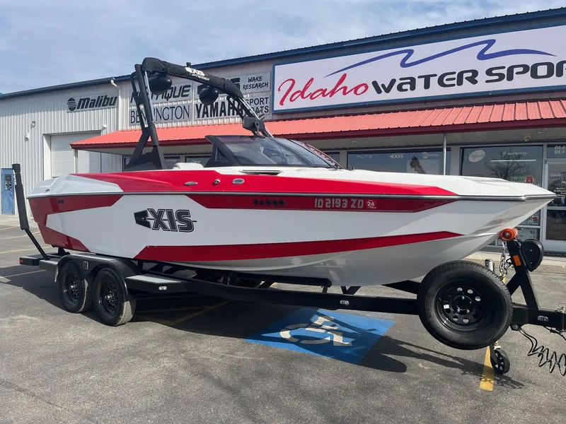 Slide: The Image of 2021 Axis A22 boat in red and white on trailer at Idaho Water Sports dealership. - 14