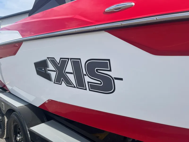 Slide: The Image of 2021 Axis A22 boat with red and white exterior detailing. - 15
