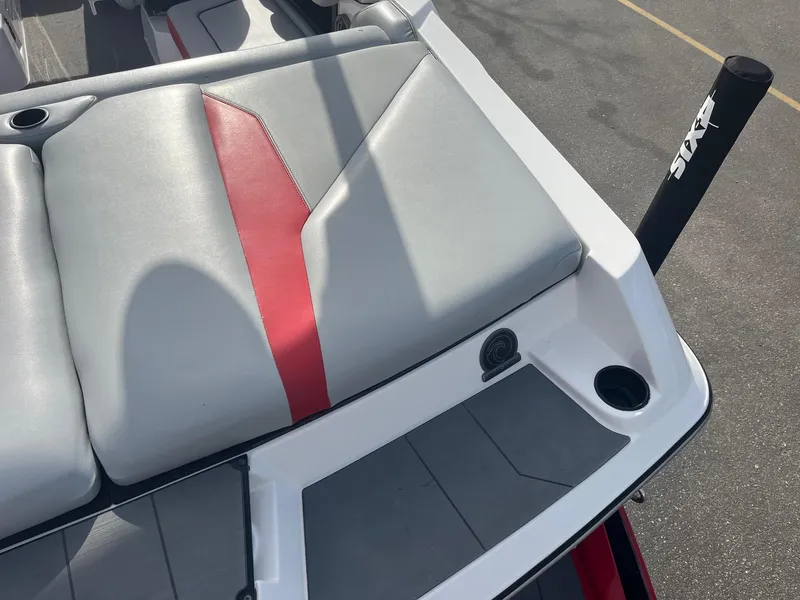 Slide: The Image of 2021 Axis A22 boat with gray and red seating, cup holders, and sleek design. - 18