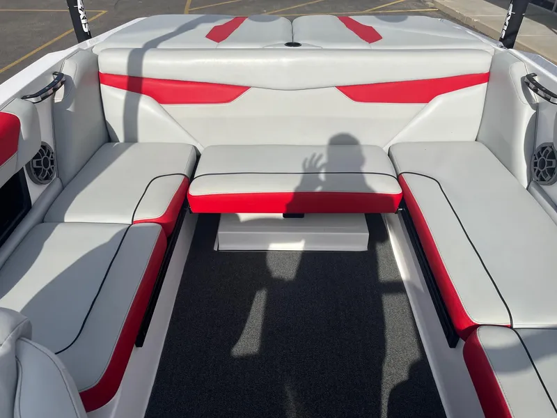 Slide: The Image of 2021 Axis A22 boat interior with red and white seating, shadow visible. - 20