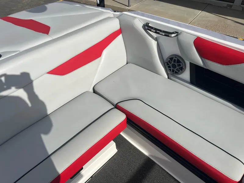 Slide: The Image of 2021 Axis A22 boat interior with red and white seating and speaker. - 24