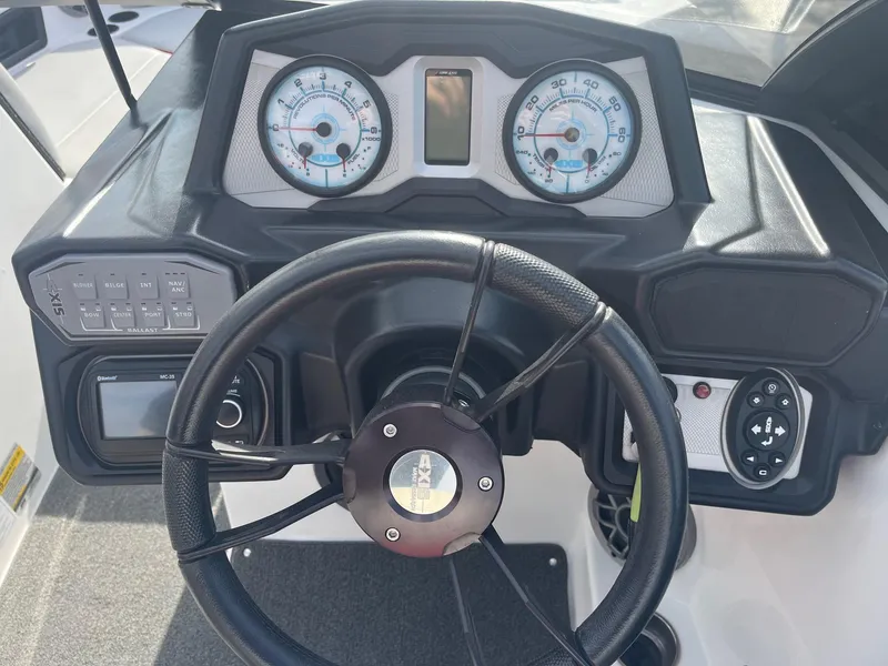 Slide: The Image of Dashboard of a 2021 Axis A22 boat with steering wheel and gauges. - 29