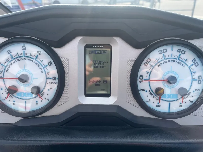Slide: The Image of Dashboard of a 2021 Axis A22 boat showing RPM and speed gauges. - 32
