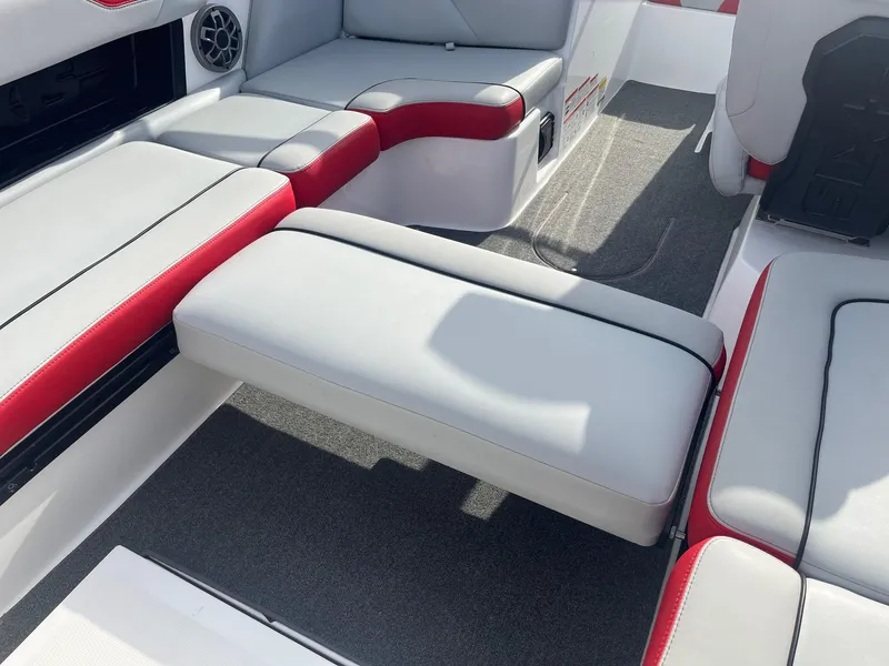 Slide: The Image of 2021 Axis A22 boat interior with red and white seating and speaker. - 33