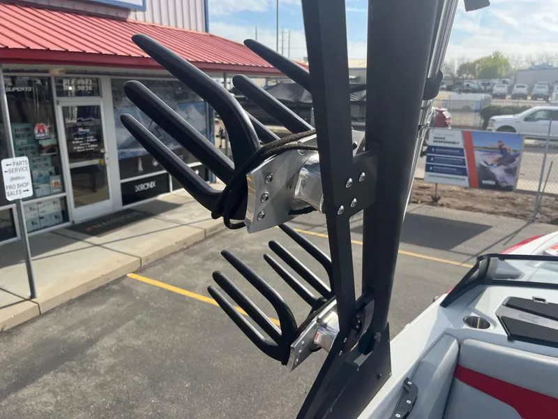 Slide: The Image of Wakeboard rack on a 2021 Axis A22 boat, parked near a service shop. - 34