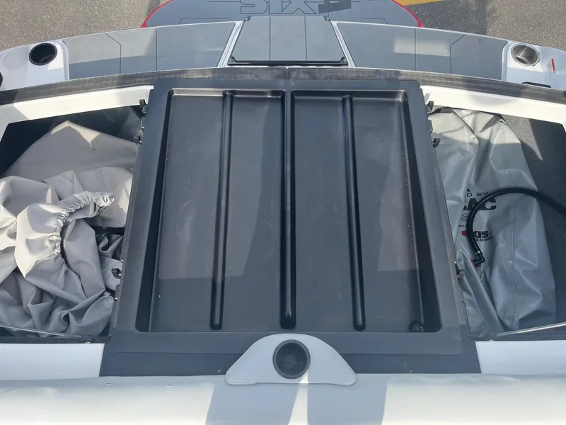 Slide: The Image of 2021 Axis A22 boat storage compartment with cover and equipment inside. - 36