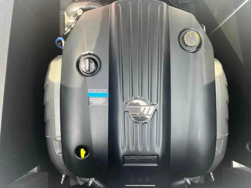 Slide: The Image of 2021 Axis A22 engine compartment with black cover and visible components. - 37