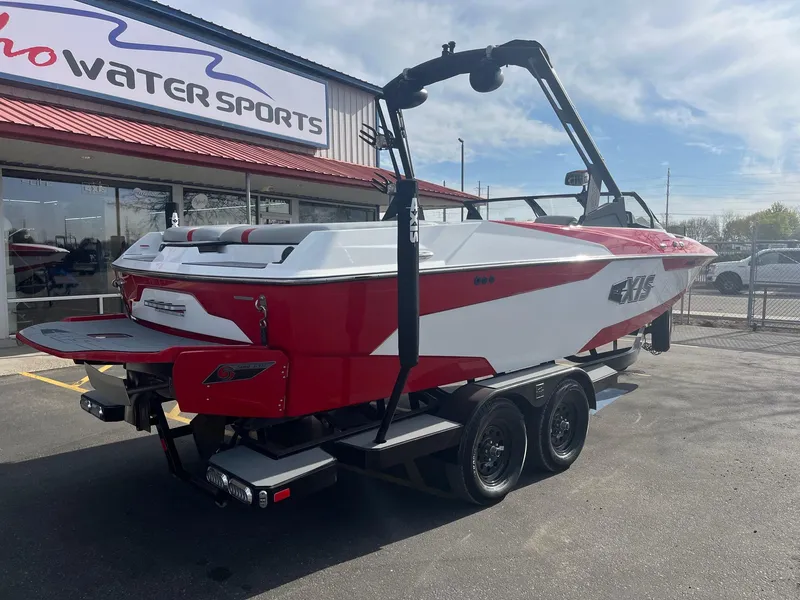 Slide: The Image of 2021 Axis A22 boat in red and white, parked at a water sports dealership. - 4