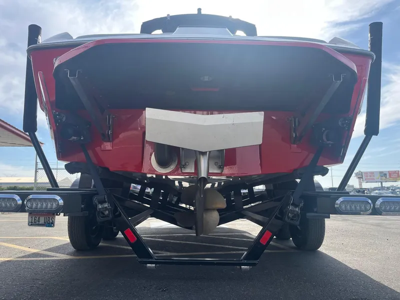 Slide: The Image of 2021 Axis A22 boat rear view on trailer in parking lot. - 6