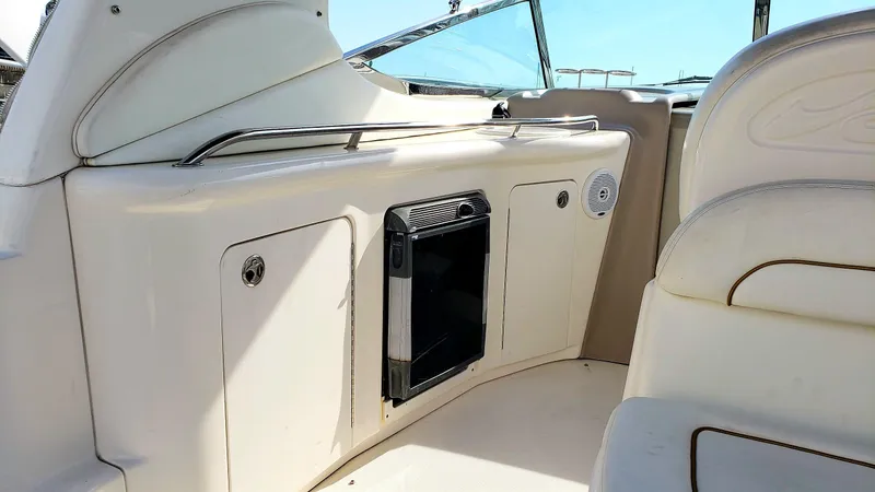 Slide: The Image of 2002 Sea Ray 300 Sundancer interior with seating and storage compartments. - 10
