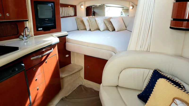 Slide: The Image of Luxurious interior of 2002 Sea Ray 300 Sundancer with cozy bed and elegant furnishings. - 12