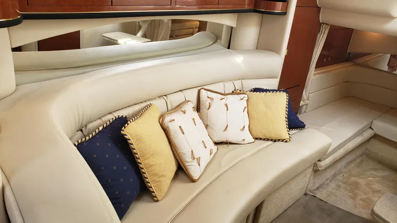 Slide: The Image of Luxurious interior of 2002 Sea Ray 300 Sundancer with plush seating and decorative pillows. - 13