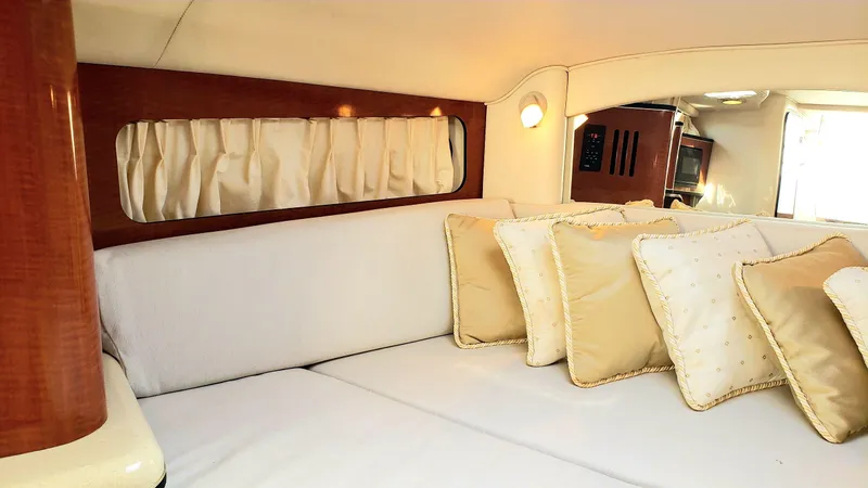 Slide: The Image of Interior of 2002 Sea Ray 300 Sundancer with plush seating and decorative pillows. - 15