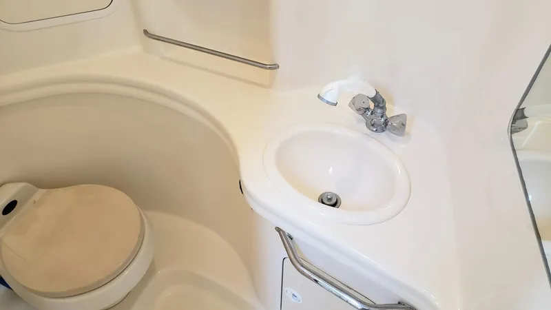 Slide: The Image of 2002 Sea Ray 300 Sundancer bathroom with sink and toilet. - 22