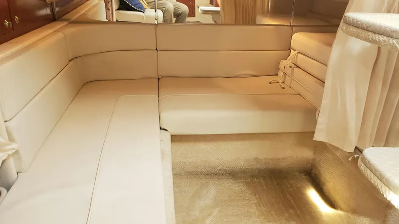 Slide: The Image of Interior of 2002 Sea Ray 300 Sundancer with beige seating and elegant design. - 25