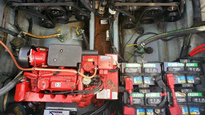 Slide: The Image of Engine compartment of a 2002 Sea Ray 300 Sundancer with visible batteries and wiring. - 35
