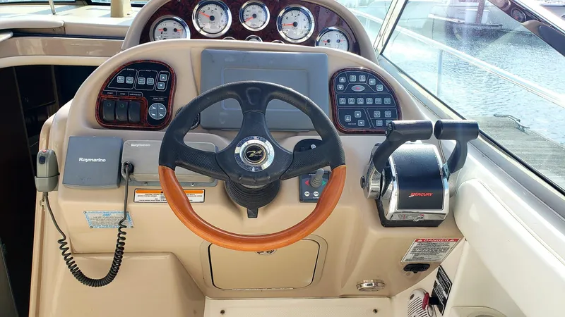 Slide: The Image of Helm of 2002 Sea Ray 300 Sundancer with steering wheel and control panel. - 6