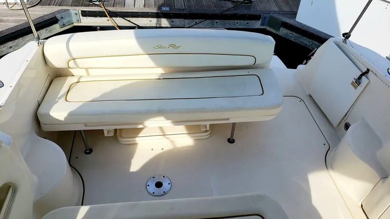 Slide: The Image of 2002 Sea Ray 300 Sundancer boat interior with cushioned seating area. - 8