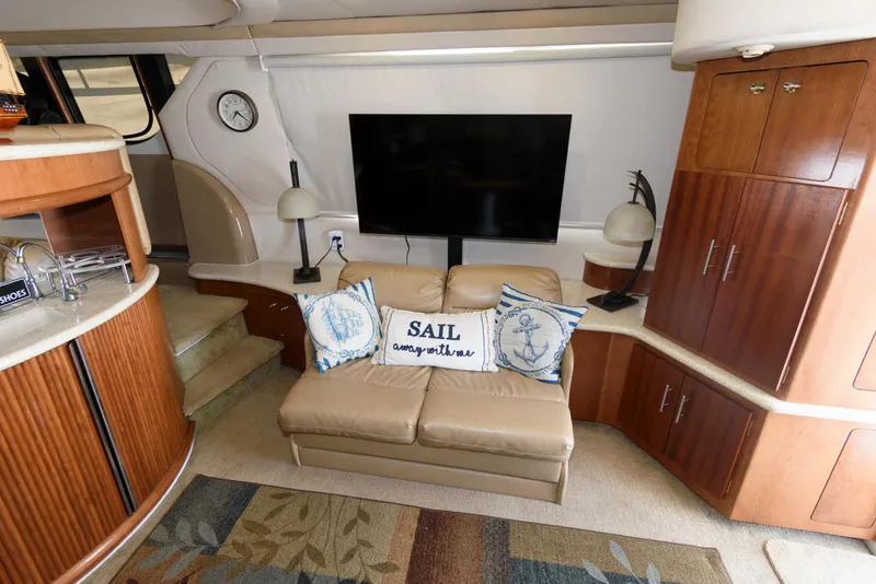 Slide: The Image of Luxurious interior of 1999 Carver 450 Voyager Pilothouse with sofa, TV, and nautical decor. - 11
