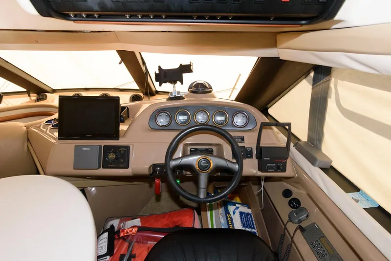 Slide: The Image of Interior cockpit of 1999 Carver 450 Voyager Pilothouse with steering wheel and navigation instruments. - 13