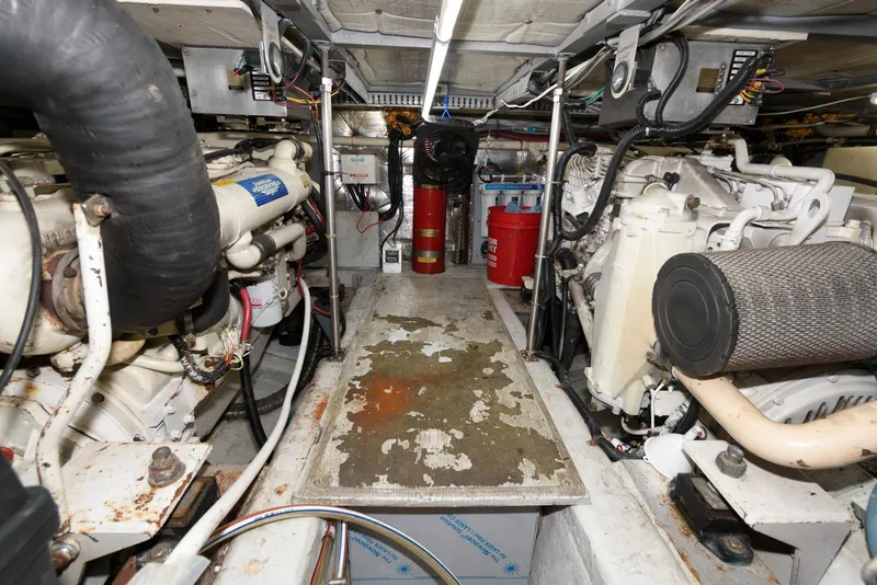 Slide: The Image of Engine room of 1999 Carver 450 Voyager Pilothouse with visible machinery and equipment. - 21