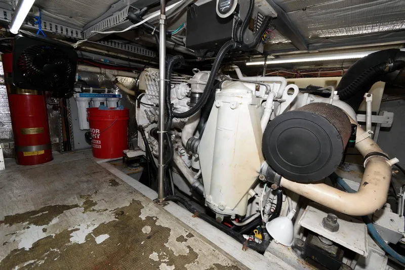 Slide: The Image of Engine room of a 1999 Carver 450 Voyager Pilothouse with visible machinery and equipment. - 22