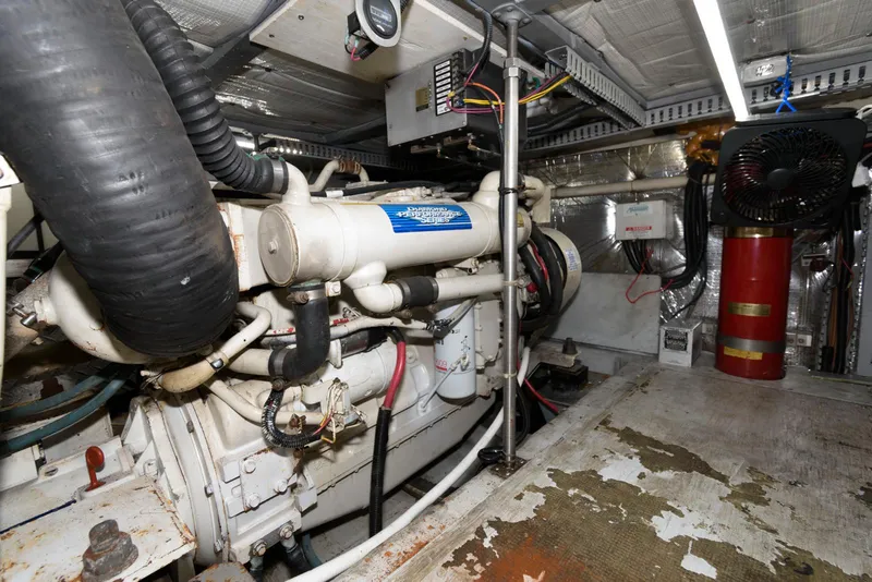Slide: The Image of Engine room of 1999 Carver 450 Voyager Pilothouse with visible machinery and equipment. - 23