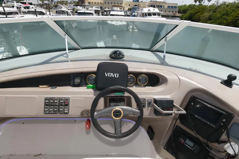 Slide: The Image of 1999 Carver 450 Voyager Pilothouse helm with steering wheel and control panel. - 6
