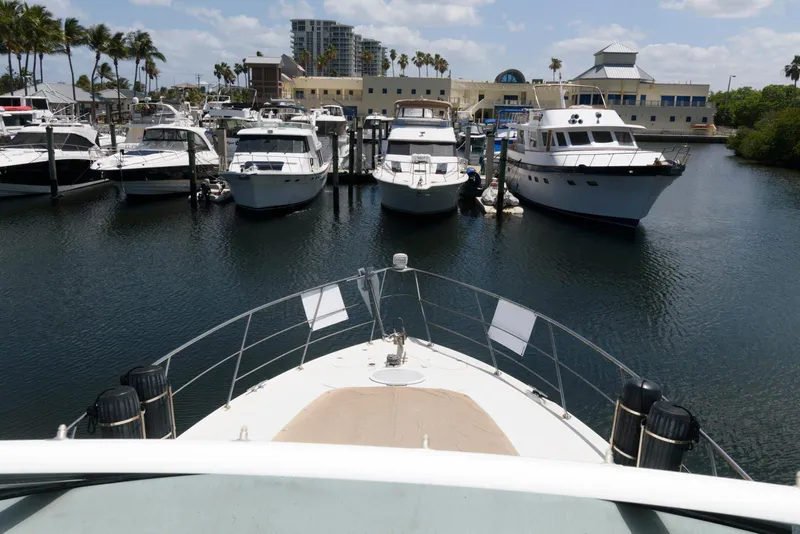 Slide: The Image of Bow view of 1999 Carver 450 Voyager Pilothouse docked at marina. - 8