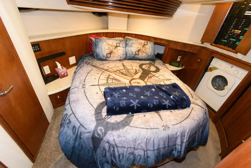 Slide: The Image of Bedroom interior of 1999 Carver 450 Voyager Pilothouse with nautical-themed bedding. - 16