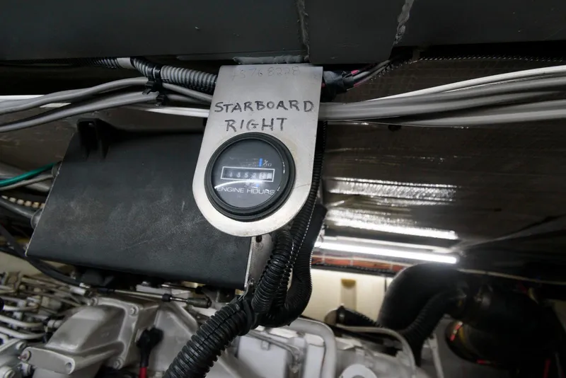 Slide: The Image of Engine room of 1999 Carver 450 Voyager Pilothouse, showing starboard engine hour meter. - 24