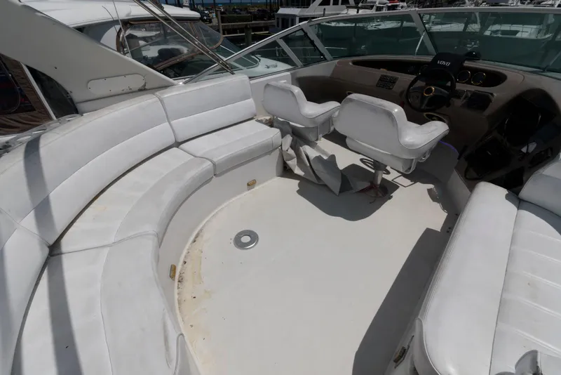 Slide: The Image of 1999 Carver 450 Voyager Pilothouse interior with white seating and helm area. - 4