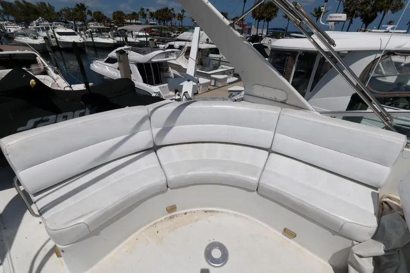 Slide: The Image of White seating area on a 1999 Carver 450 Voyager Pilothouse yacht, docked at a marina. - 5