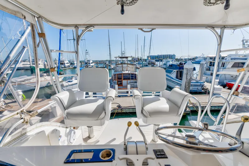 Slide: The Image of Cockpit view of 1999 Viking 47 Convertible yacht docked at marina. - 10