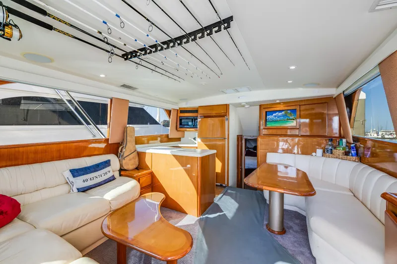 Slide: The Image of Luxurious interior of a 1999 Viking 47 Convertible yacht with elegant seating and modern amenities. - 16