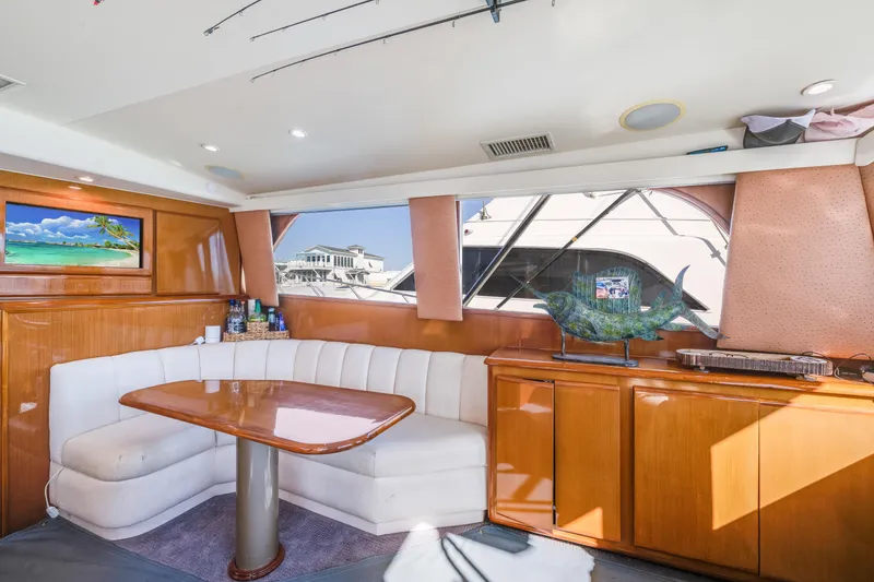 Slide: The Image of Interior of 1999 Viking 47 Convertible yacht with dining area and scenic window view. - 18