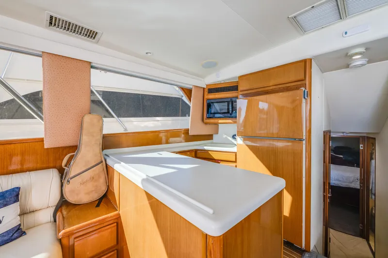 Slide: The Image of Interior of 1999 Viking 47 Convertible yacht with kitchen and guitar case. - 19