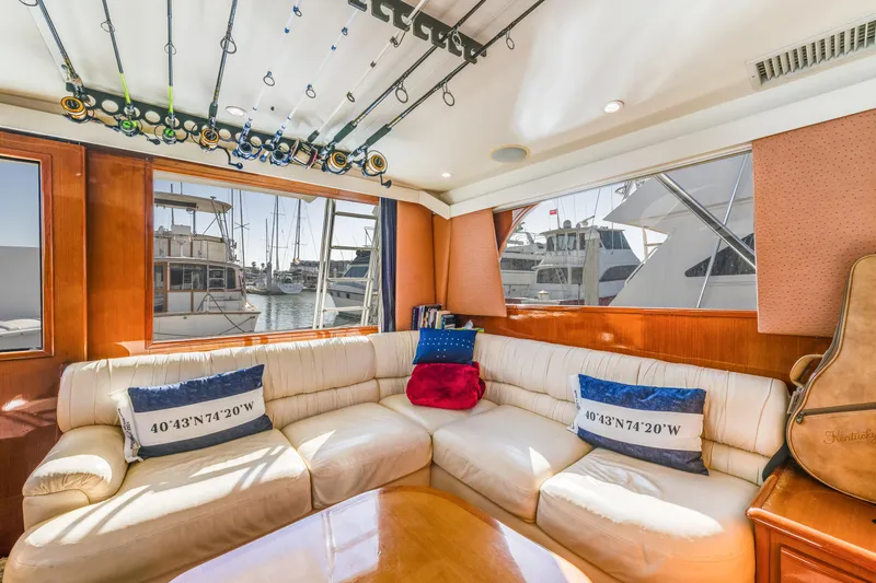 Slide: The Image of Luxurious interior of 1999 Viking 47 Convertible yacht with plush seating and fishing rods. - 20