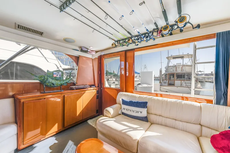 Slide: The Image of Interior of 1999 Viking 47 Convertible yacht with fishing rods and comfortable seating. - 21