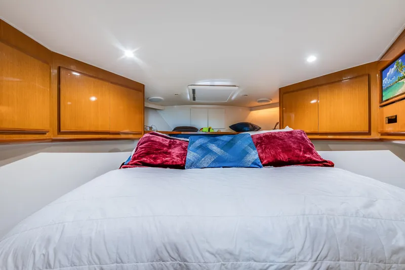 Slide: The Image of Luxurious bedroom interior of 1999 Viking 47 Convertible yacht with plush bedding. - 23