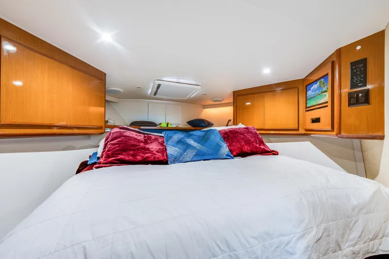 Slide: The Image of Luxurious cabin interior of 1999 Viking 47 Convertible yacht with cozy bedding. - 24