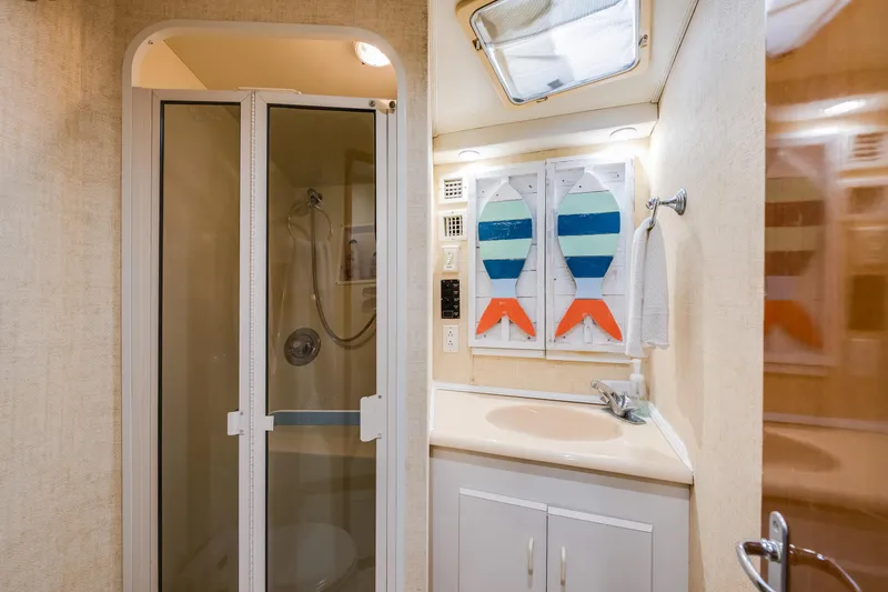 Slide: The Image of Bathroom interior of 1999 Viking 47 Convertible yacht with shower and sink. - 28