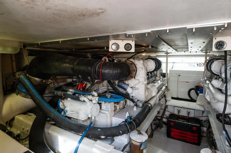 Slide: The Image of Engine room of a 1999 Viking 47 Convertible yacht, showcasing machinery and equipment. - 31