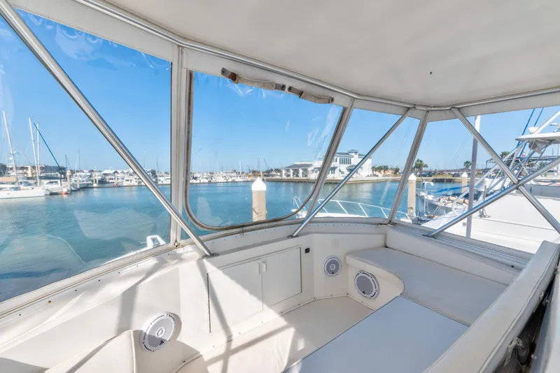 Slide: The Image of 1999 Viking 47 Convertible yacht interior with marina view through windows. - 7